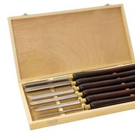 Werkzeugsatz mit sechs verschiedenen Werkzeugen in einem Holzkasten. Die Werkzeuge sind in Scheiden aus Holz oder Kunststoff. Produktname: Werkzeugsatz, 6-fach.