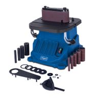 Scheppach oscillating belt and spindle sander OSM600 featuring included accessories: belts, grinding wheels, adaptors, and clamps