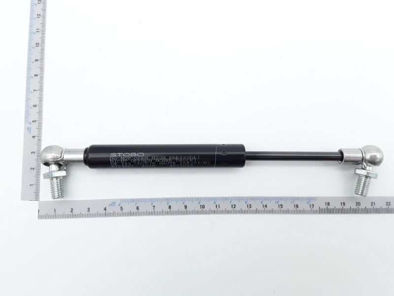 Gasfeder Liftomat von Scheppach, gezeigt von der Seite mit einem Lineal zur Größenveranschaulichung.