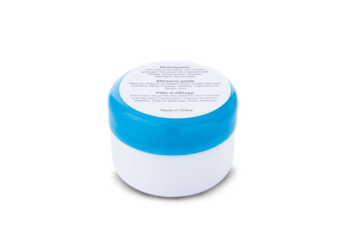 Abziehpaste von Scheppach, weißer Behälter mit blauem Band, Ansicht von oben.