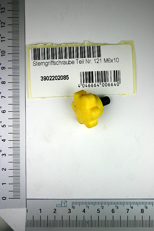 Sterngriffschraube M6x10, Teil Nr. 121, gelbe Kunststoffkappe mit schwarzem Griff, von vorne fotografiert.