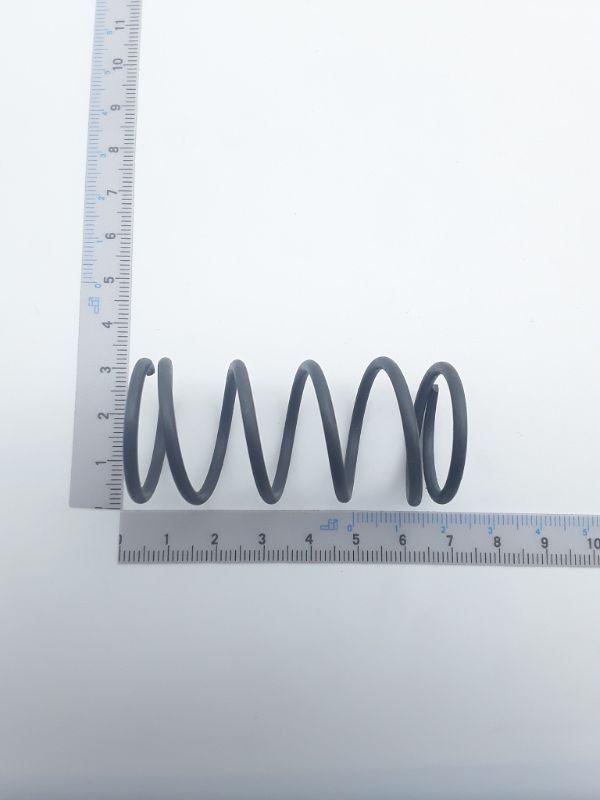 Druckfeder (Scheppach) mit spiralförmiger Form, Messlatte für Größenvergleich