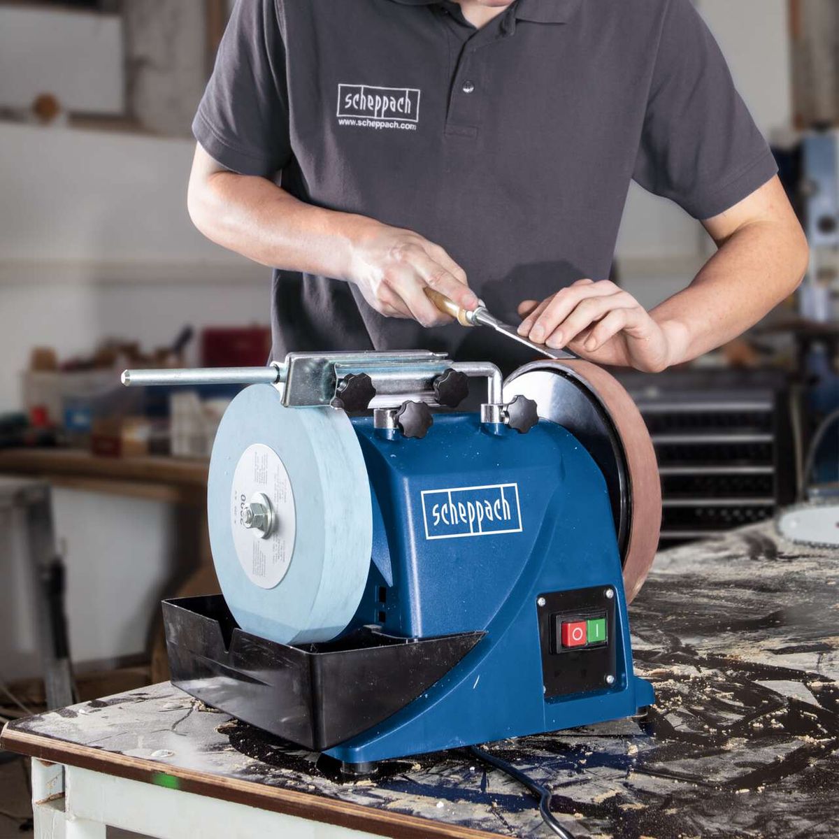 The Whetstone Bench Grinder Tiger 2000S by Scheppach with a 200mm leather honing wheel. It features a sturdy metal frame and an on/off switch. The system is perfect for precise grinding and honing.