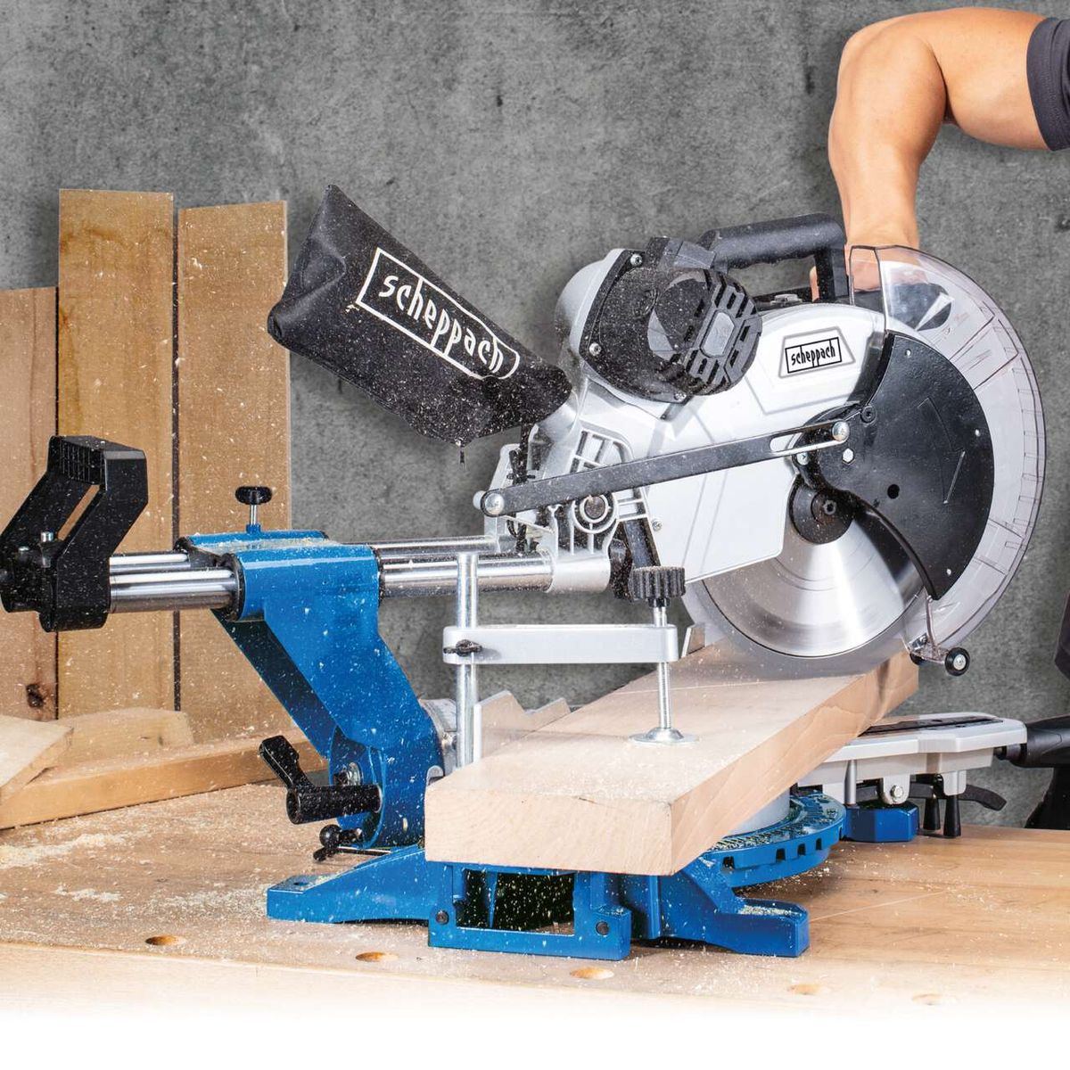 Scheppach sliding mitre saw with blade change clamp and workpiece holder, showing blade and cutting setup
