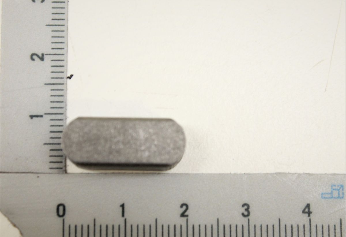 Passfeder 8x8x18, Ansicht von der Seite, neben einem Lineal zur Größenveranschaulichung.