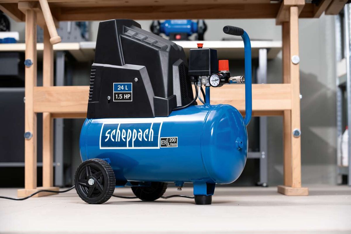 Scheppach HC30ox air compressor, 24L tank, 200L/min, 1.5HP, 230V, oil-free and low-maintenance. Side view of the compressor on a wooden shelf.