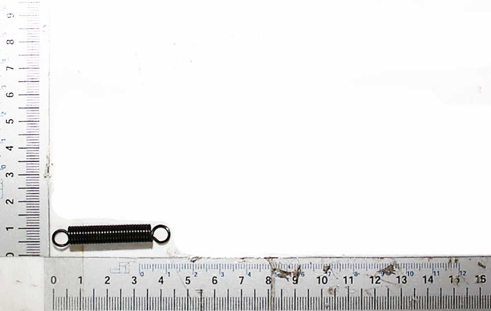 Eine Zugfeder Ø8x44 von Scheppach, dargestellt von der Seite auf einem Lineal als Maßstab.