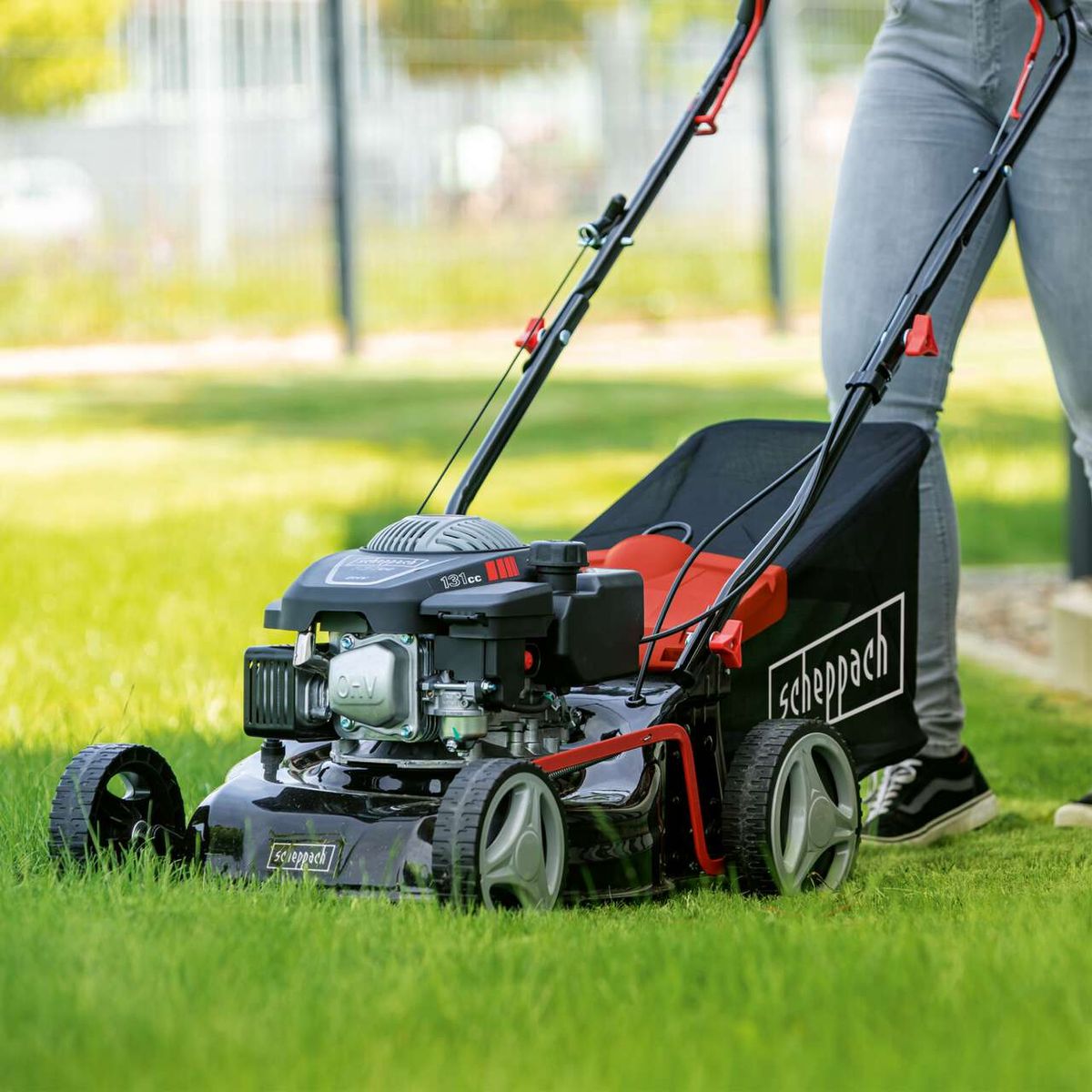 The Scheppach Petrol Push Lawnmower MP132-42 with 42cm cutting width and 45L grass bag. OHC engine with 131cc displacement. Sturdy design for efficient mowing.